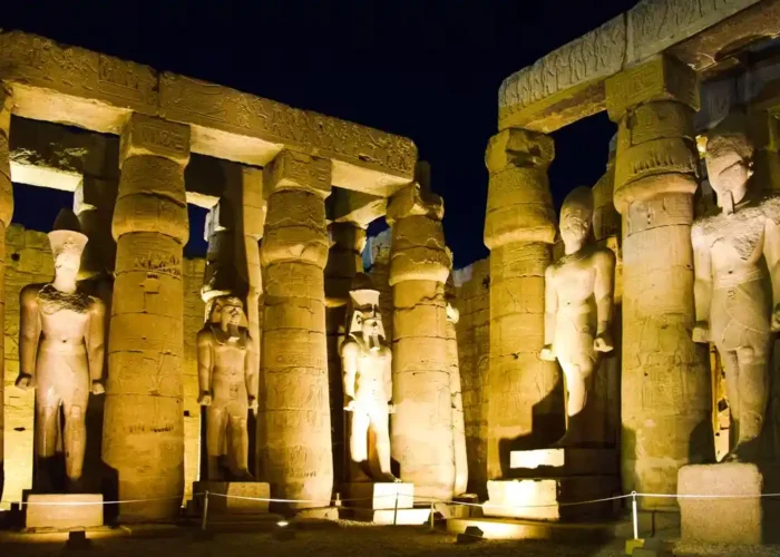 The illuminated Luxor Temple at night showing beautiful ancient carvings.
