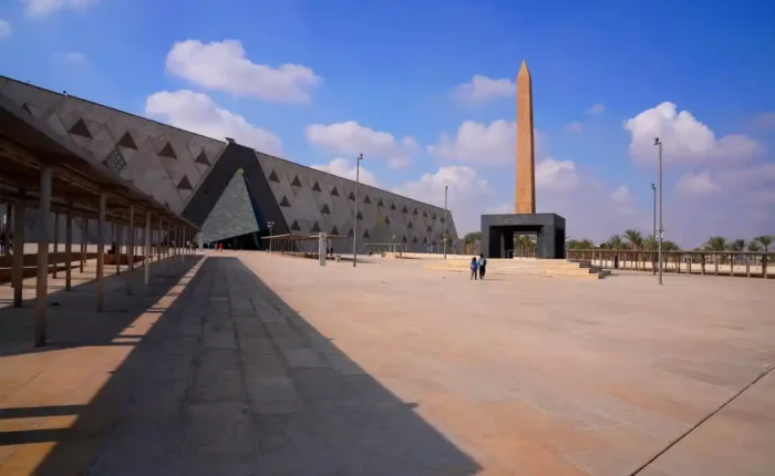 Modern architectural exterior of the Grand Egyptian Museum GEM in Giza on a clear sunny day.